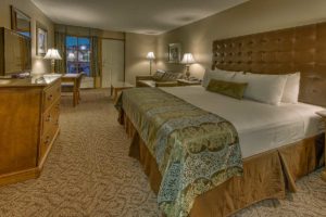 king bed with seating area in suite at Willow Brook Lodge
