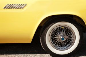 hubcap on yellow classic car