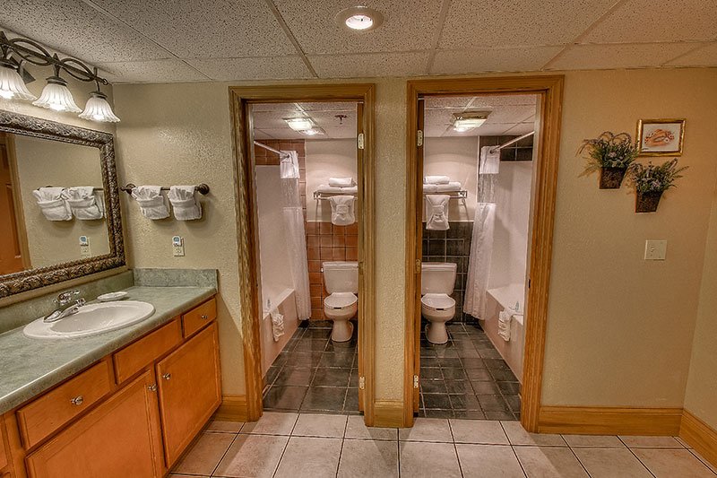 two bathrooms with vanity in family suite at Willow Brook Lodge