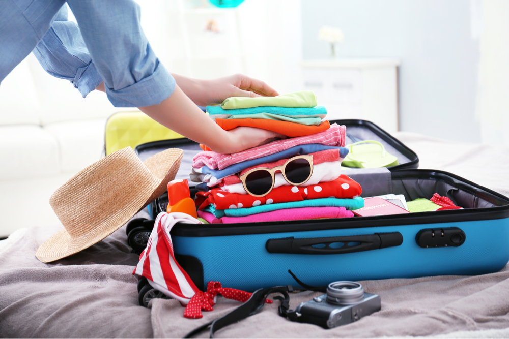 Woman packs a suitcase