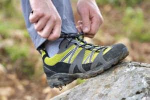 A man ties his tennis shoe