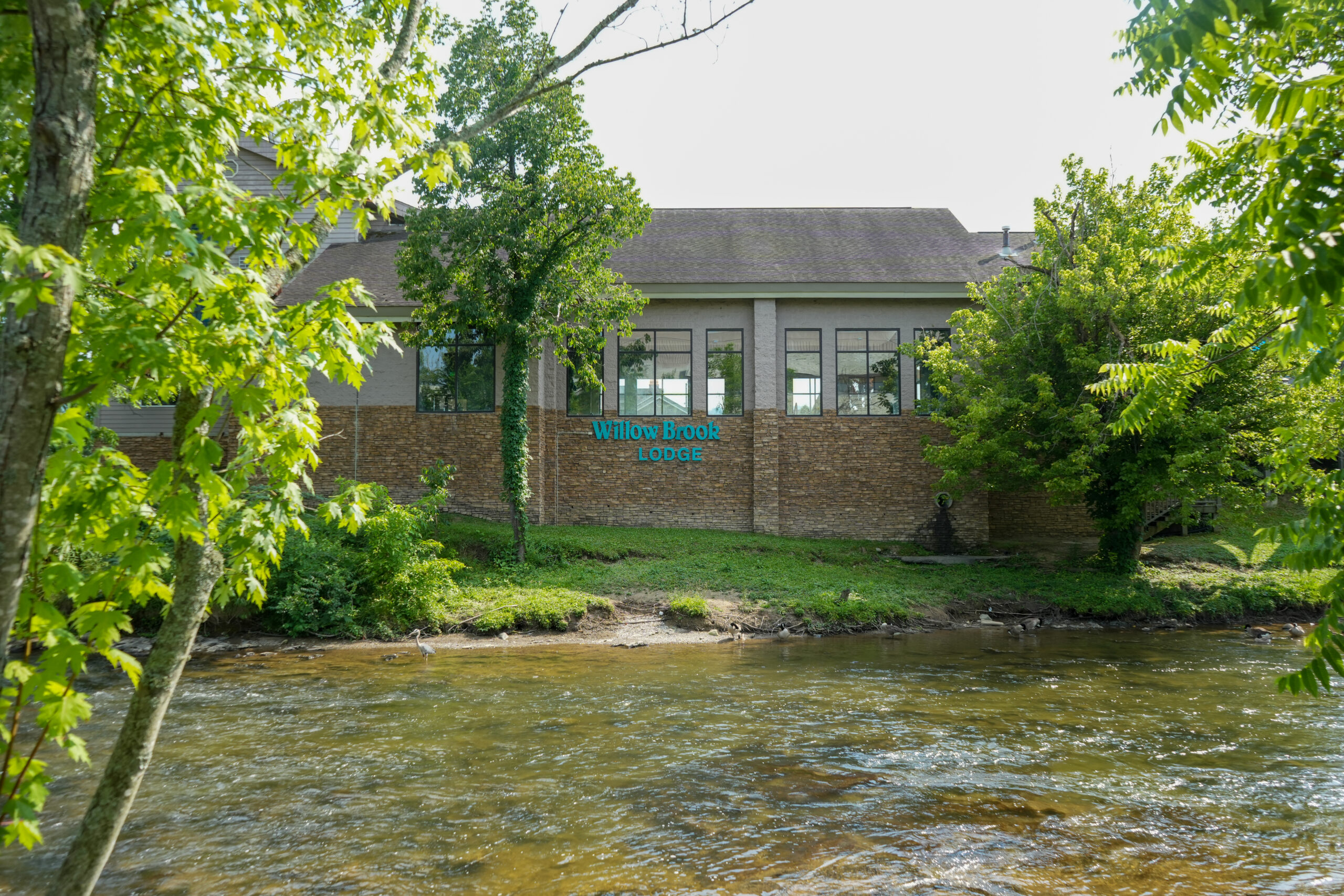Willow Brook Lodge River Walk View Exterior view of Willow Brook Lodge motel next to River Walk and LeConte Center in Pigeon Forge, Tennessee